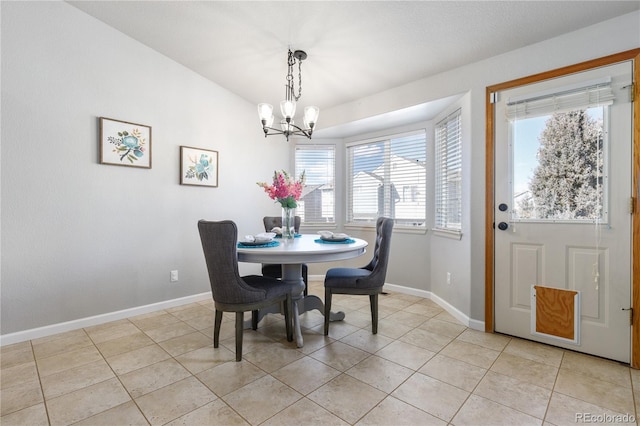 dining area with baseboards, an inviting chandelier, and light tile patterned floors