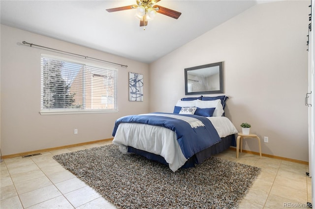 bedroom with light tile patterned floors, visible vents, a ceiling fan, vaulted ceiling, and baseboards