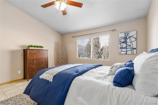 bedroom featuring ceiling fan, vaulted ceiling, baseboards, and light tile patterned floors