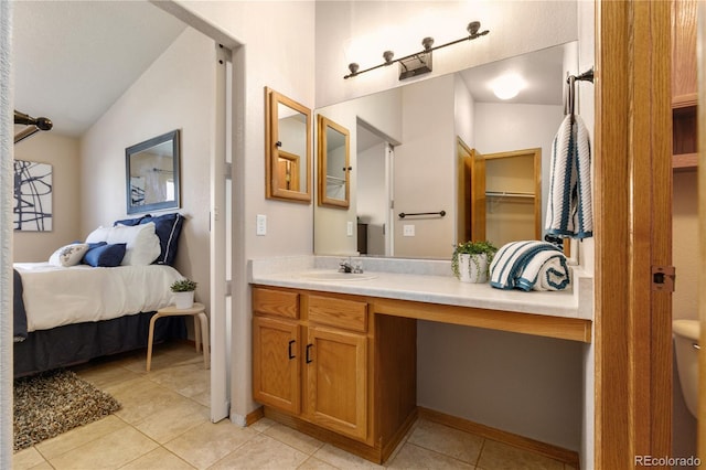 full bathroom featuring lofted ceiling, toilet, vanity, ensuite bath, and tile patterned floors