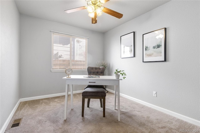 carpeted office with ceiling fan, visible vents, and baseboards