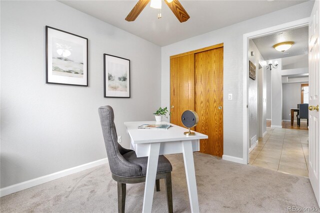 dining room with baseboards, light tile patterned flooring, a ceiling fan, and light colored carpet