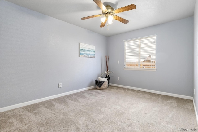 spare room featuring carpet flooring, ceiling fan, and baseboards