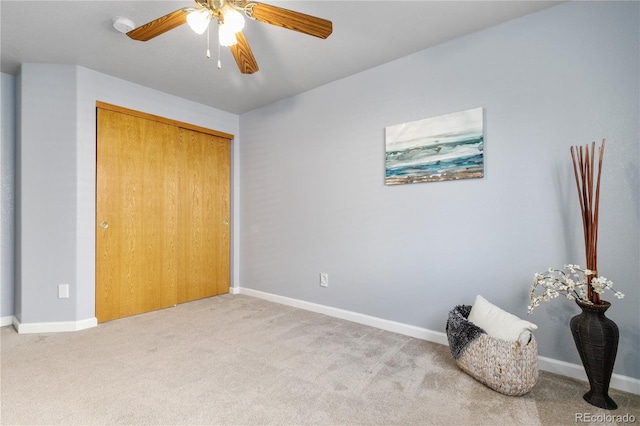 unfurnished bedroom featuring carpet floors, a closet, ceiling fan, and baseboards