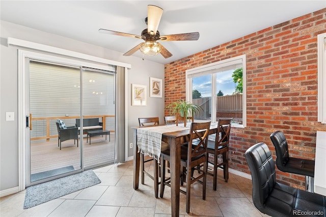 561 James St, Highlands Ranch, CO 80126 - dining space featuring light tile patterned flooring, a ceiling fan, and brick wall
