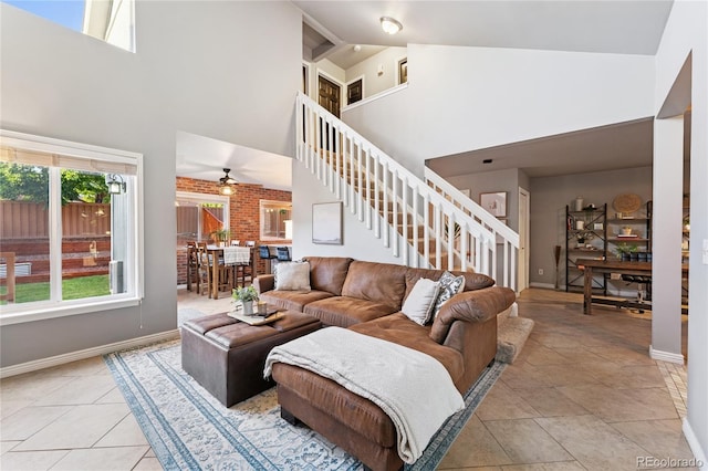 561 James St, Highlands Ranch, CO 80126 - living room with stairs, high vaulted ceiling, ceiling fan, and light tile patterned floors