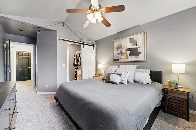 561 James St, Highlands Ranch, CO 80126 - bedroom with a barn door, light colored carpet, vaulted ceiling, a ceiling fan, and a spacious closet