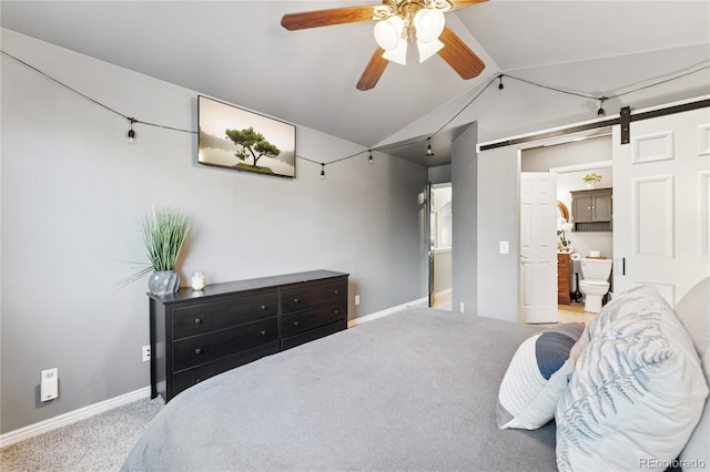561 James St, Highlands Ranch, CO 80126 - carpeted bedroom with lofted ceiling, a barn door, ceiling fan, and ensuite bath