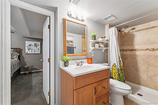 561 James St, Highlands Ranch, CO 80126 - ensuite bathroom featuring vanity, tiled shower, and a textured ceiling