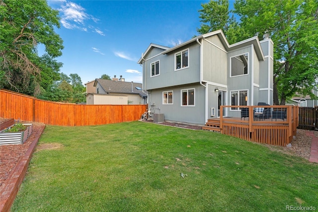 561 James St, Highlands Ranch, CO 80126 - rear view of property featuring a fenced backyard, a vegetable garden, a chimney, and a wooden deck