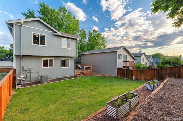 561 James St, Highlands Ranch, CO 80126 - back of property with a garden, a fenced backyard, and a wooden deck