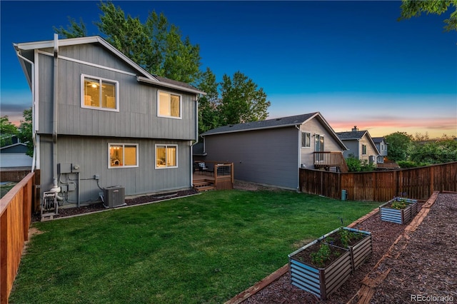 561 James St, Highlands Ranch, CO 80126 - rear view of property with a vegetable garden, a fenced backyard, and a deck
