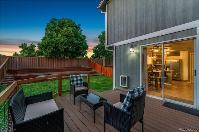 561 James St, Highlands Ranch, CO 80126 - deck at dusk with a fenced backyard and outdoor lounge area