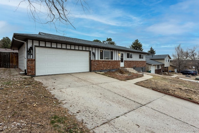 ranch-style home featuring driveway, fence, board and batten siding, an attached garage, and brick siding