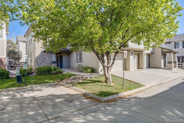 obstructed view of property with concrete driveway, a garage, and stone siding