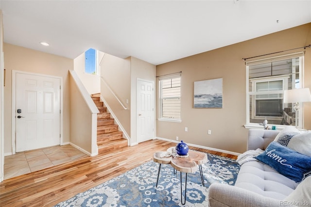 living area with stairs, wood finished floors, baseboards, and recessed lighting