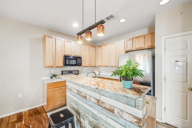 kitchen featuring stainless steel appliances, light brown cabinetry, baseboards, light wood-style flooring, and recessed lighting
