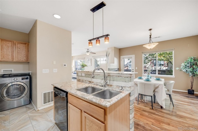 kitchen with washer / dryer, a sink, dishwasher, and light brown cabinetry
