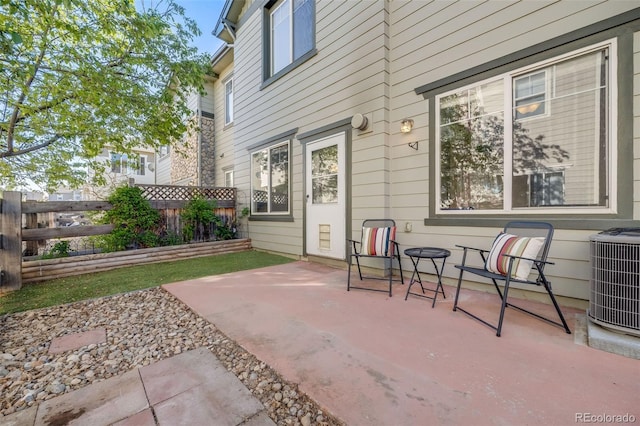 view of patio featuring central AC unit and fence