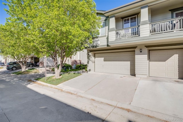 townhome / multi-family property featuring an attached garage and concrete driveway