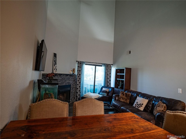 living room featuring a towering ceiling and a fireplace