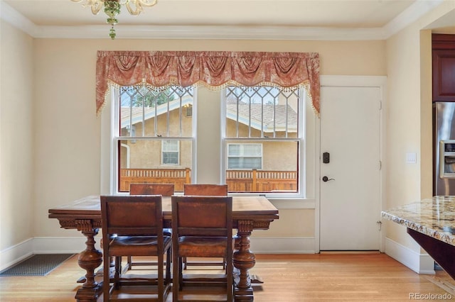 2006 N Cascade Ave, Colorado Springs, CO 80907 - dining space featuring light wood-style floors, ornamental molding, baseboards, and visible vents