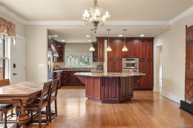 2006 N Cascade Ave, Colorado Springs, CO 80907 - kitchen featuring a center island, a breakfast bar area, light wood finished floors, and appliances with stainless steel finishes