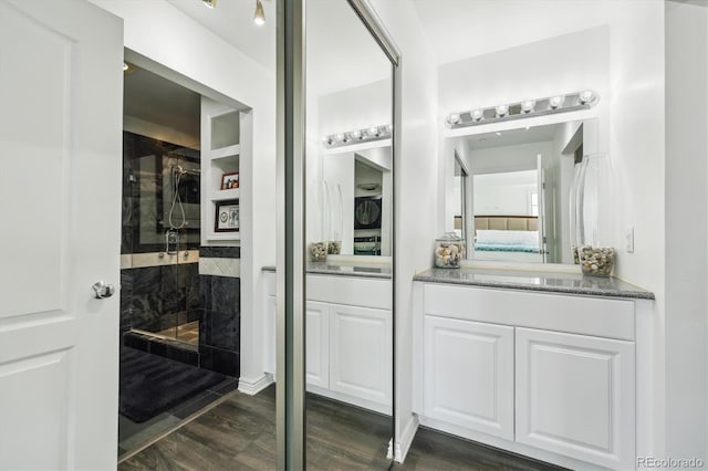 300 W 11th Ave Unit 15C, Denver, CO 80204 - ensuite bathroom with a walk in shower, vanity, and wood finished floors