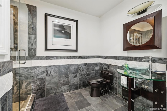 300 W 11th Ave Unit 15C, Denver, CO 80204 - bathroom with tile walls, a stall shower, toilet, vanity, and wainscoting