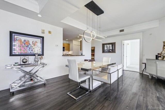 300 W 11th Ave Unit 15C, Denver, CO 80204 - dining room with dark wood finished floors, recessed lighting, baseboards, a raised ceiling, and ornamental molding
