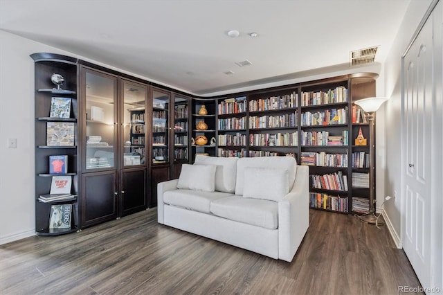 300 W 11th Ave Unit 15C, Denver, CO 80204 - living area featuring wood finished floors, wall of books, and baseboards