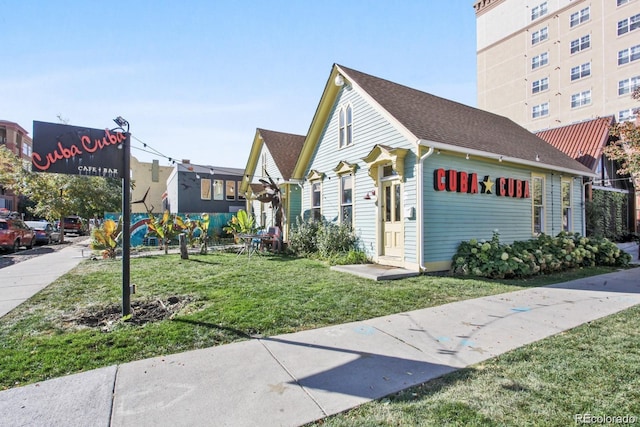300 W 11th Ave Unit 15C, Denver, CO 80204 - view of side of home featuring a lawn and roof with shingles