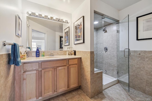 300 W 11th Ave Unit 15C, Denver, CO 80204 - bathroom featuring a stall shower, tile walls, vanity, and tile patterned floors