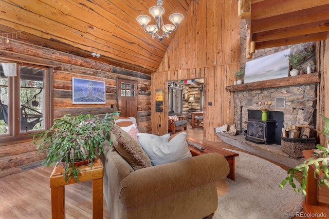 18680 Wapiti Cir, Buena Vista, CO 81211 - living room with a wood stove, high vaulted ceiling, wooden ceiling, a chandelier, and wood finished floors