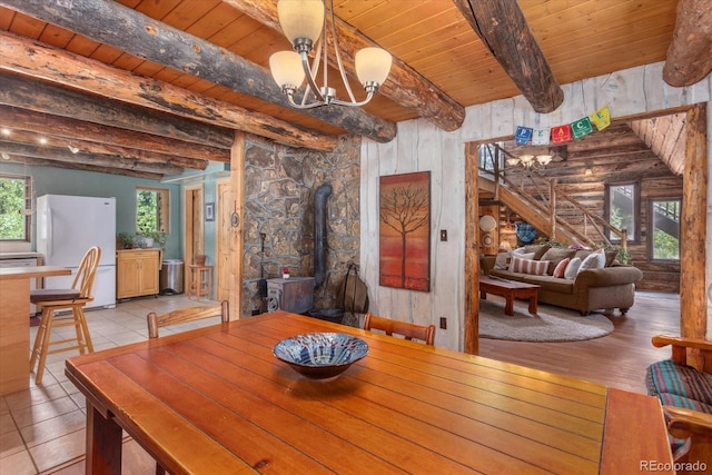 18680 Wapiti Cir, Buena Vista, CO 81211 - dining space featuring a wood ceiling with exposed beams, a chandelier, and a wood stove