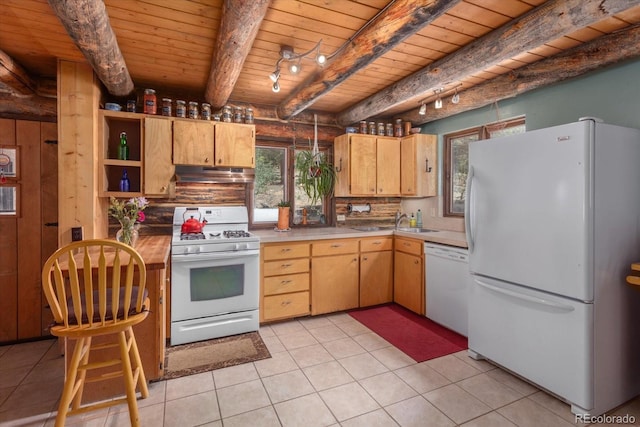 18680 Wapiti Cir, Buena Vista, CO 81211 - kitchen with white appliances, under cabinet range hood, a wood ceiling with exposed beams, light countertops, and rustic walls