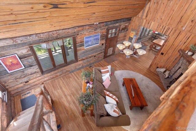18680 Wapiti Cir, Buena Vista, CO 81211 - living room featuring wooden walls, wood-type flooring, and a chandelier