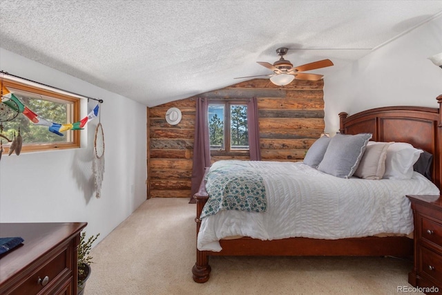 18680 Wapiti Cir, Buena Vista, CO 81211 - bedroom with log walls, vaulted ceiling, a textured ceiling, light carpet, and ceiling fan