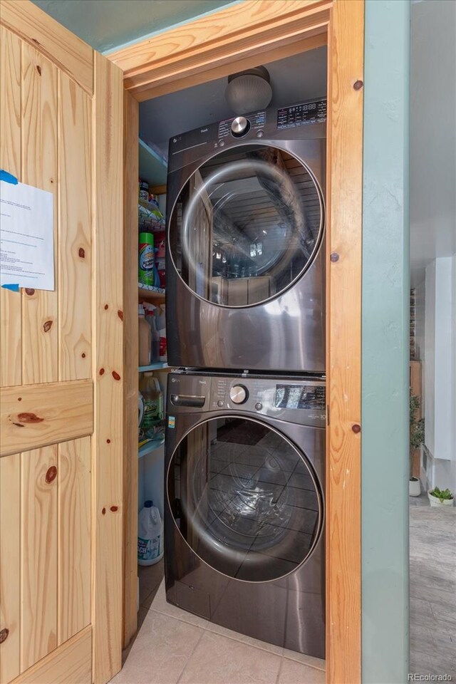 18680 Wapiti Cir, Buena Vista, CO 81211 - laundry room featuring stacked washer / dryer and tile patterned floors
