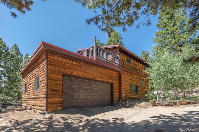 18680 Wapiti Cir, Buena Vista, CO 81211 - view of side of home with a garage and a deck