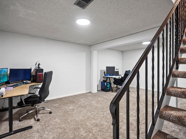 home office with visible vents, baseboards, carpet, and a textured ceiling