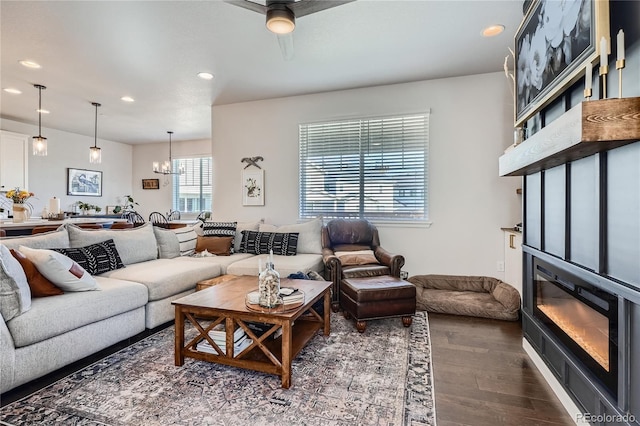 21038 E Quincy Pl, Aurora, CO 80015 - living area featuring dark wood-style flooring, recessed lighting, a chandelier, and a glass covered fireplace