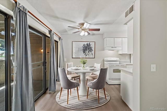 15202 E Hampden Cir Unit F2, Aurora, CO 80014 - dining space with light wood finished floors and a ceiling fan