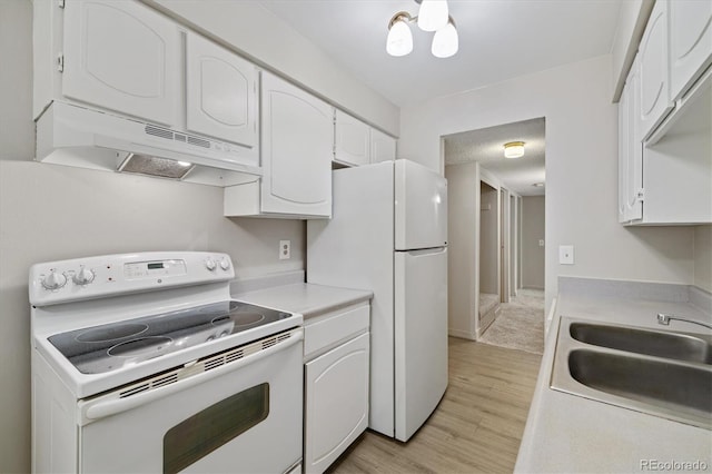 15202 E Hampden Cir Unit F2, Aurora, CO 80014 - kitchen featuring white appliances, under cabinet range hood, white cabinets, light countertops, and light wood finished floors