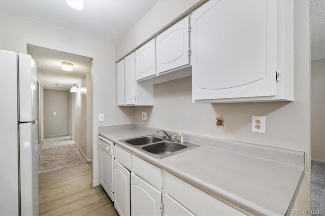 15202 E Hampden Cir Unit F2, Aurora, CO 80014 - kitchen featuring white appliances, white cabinets, light wood-type flooring, and light countertops