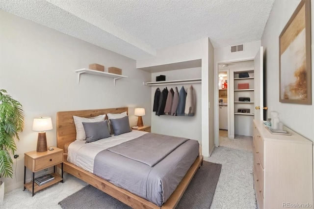15202 E Hampden Cir Unit F2, Aurora, CO 80014 - bedroom with light colored carpet and a textured ceiling