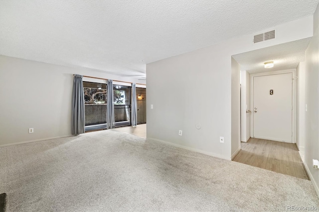 15202 E Hampden Cir Unit F2, Aurora, CO 80014 - carpeted empty room with a textured ceiling and baseboards
