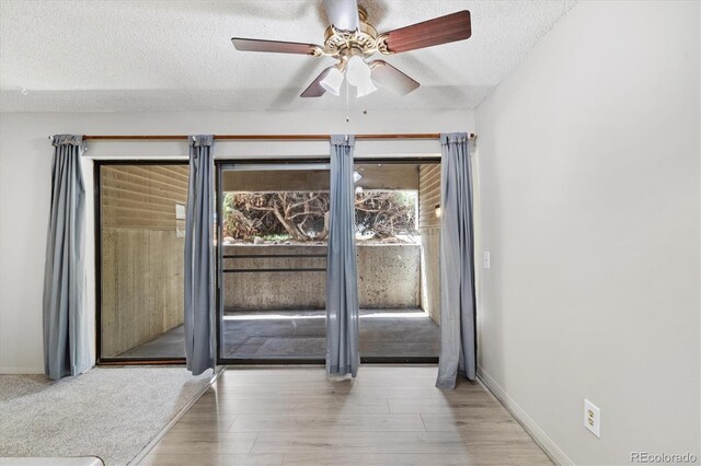 15202 E Hampden Cir Unit F2, Aurora, CO 80014 - empty room with a textured ceiling, a ceiling fan, and wood finished floors