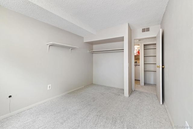 15202 E Hampden Cir Unit F2, Aurora, CO 80014 - unfurnished bedroom featuring carpet, a closet, and a textured ceiling