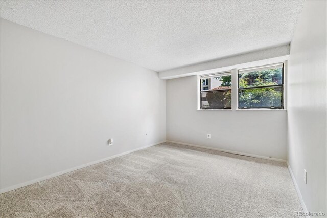 15202 E Hampden Cir Unit F2, Aurora, CO 80014 - carpeted empty room with a textured ceiling and baseboards